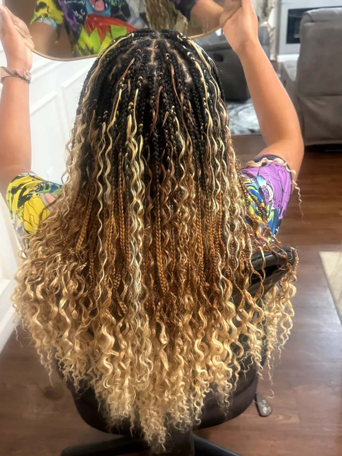 Bohemian knotless braids with loose honey-blonde curly pieces throughout, top view